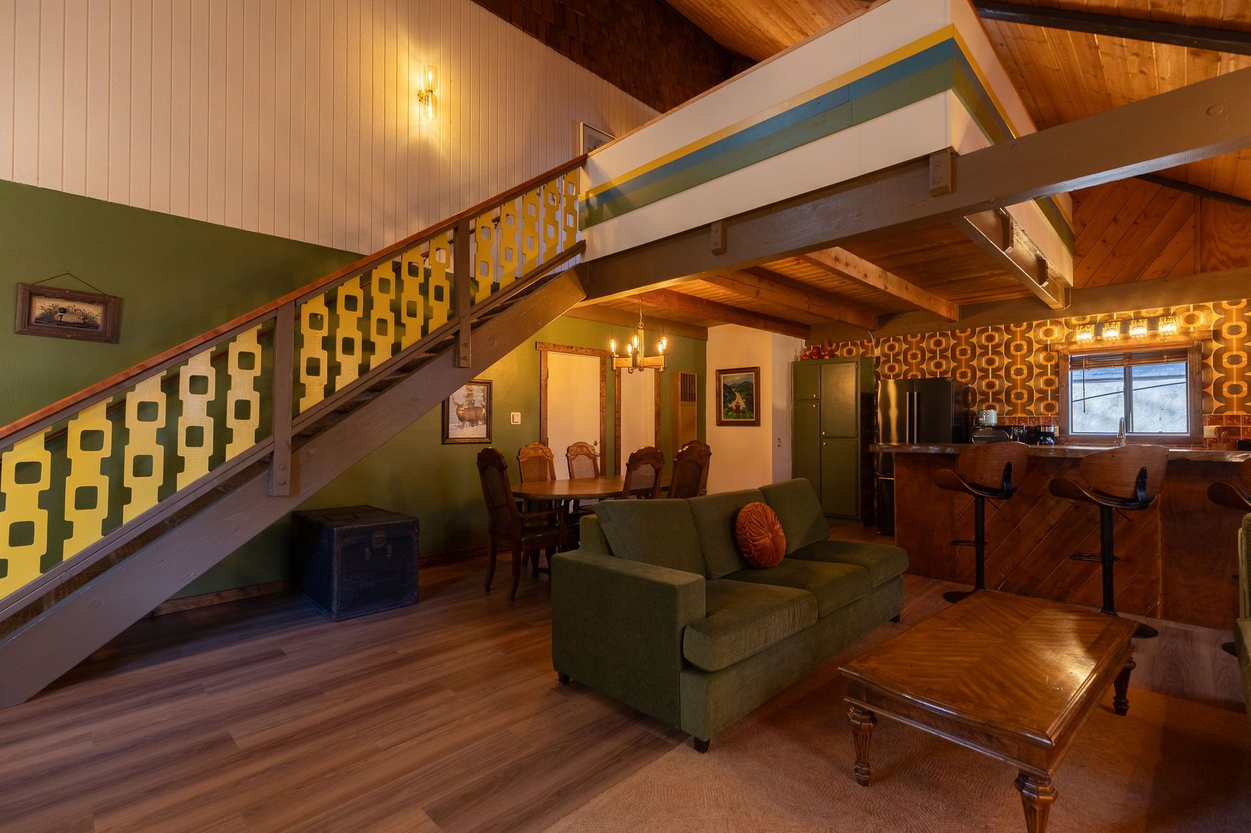 Loft with green sofa and yellow stairs
