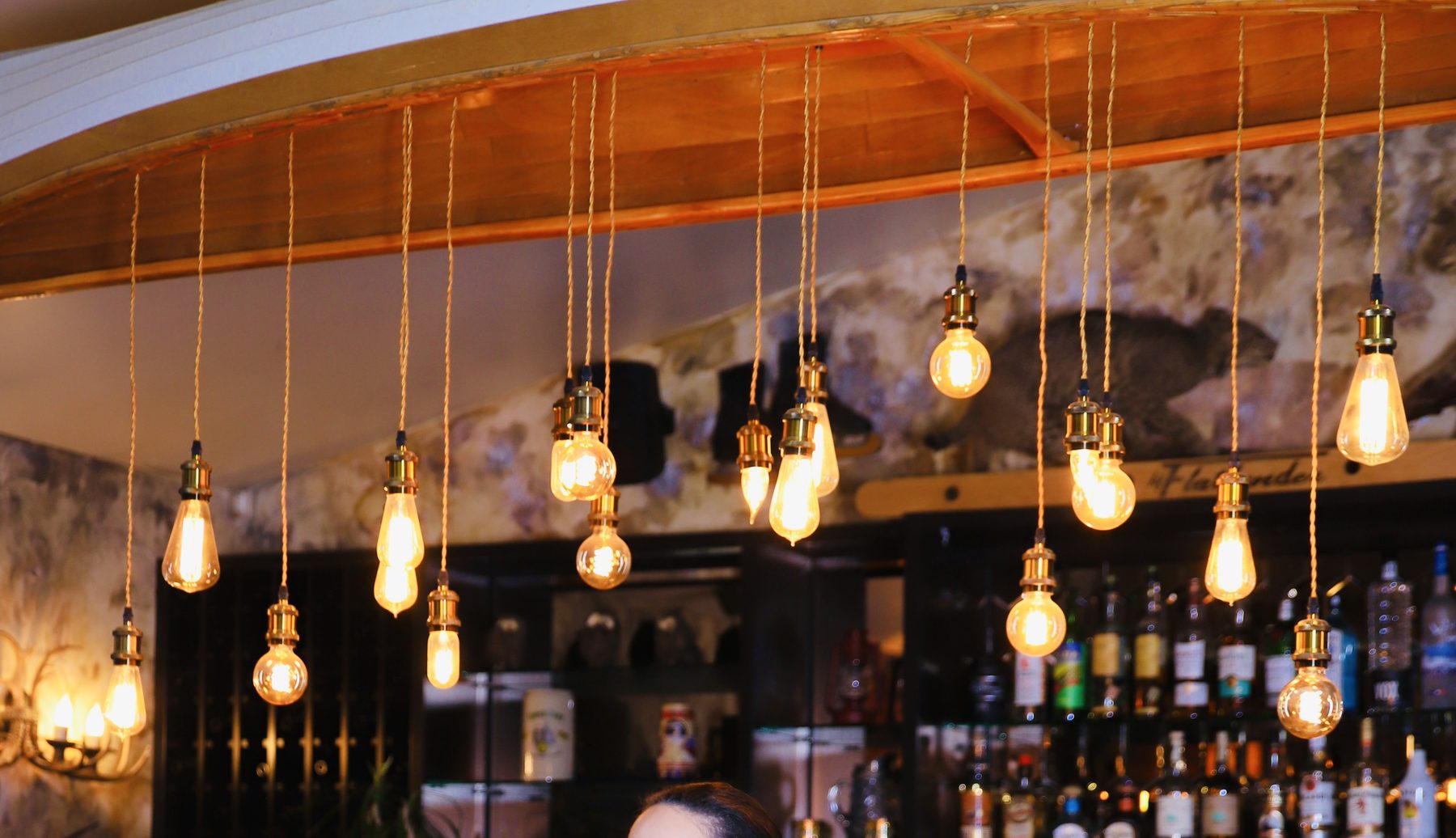 The Flatlander bar at Sessions — upside-down canoe with Edison bulbs